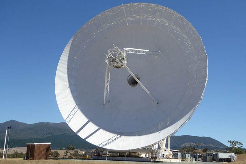 Front view of DSS34 showing the round dish, hole in the centre of the dish and quadrapod legs