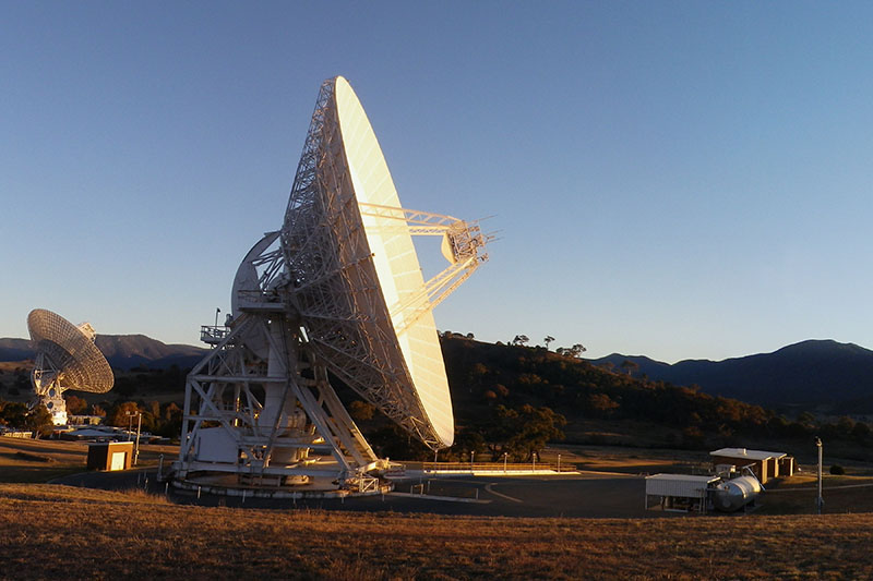 Side on view of DSS34 with DSS43 in the background on the left and hills behind
