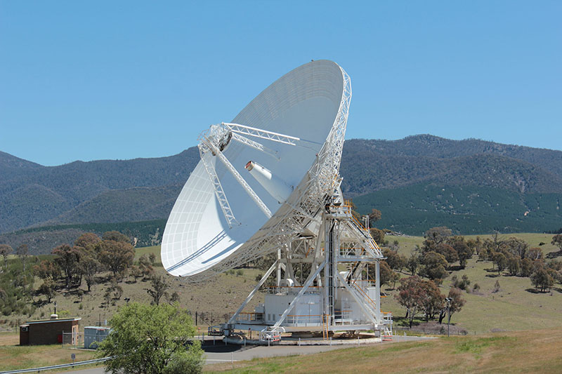 Deep Space Station 45 on an angle in front of hills, showing the quad legs and receiving cone