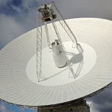 Close up shot of the dish of Deep Space Station 43 showing the cone structure in the middle and the quad legs and subreflector.
