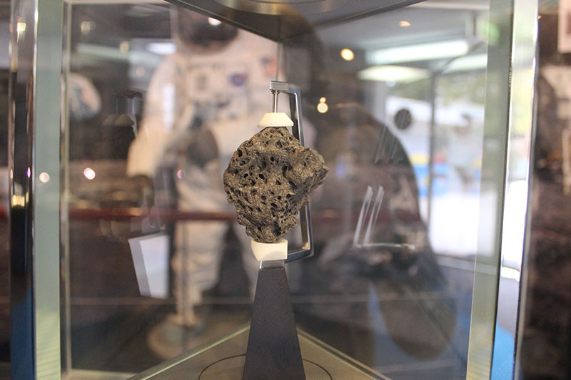 Moon rock in a case. The rock has holes in it.